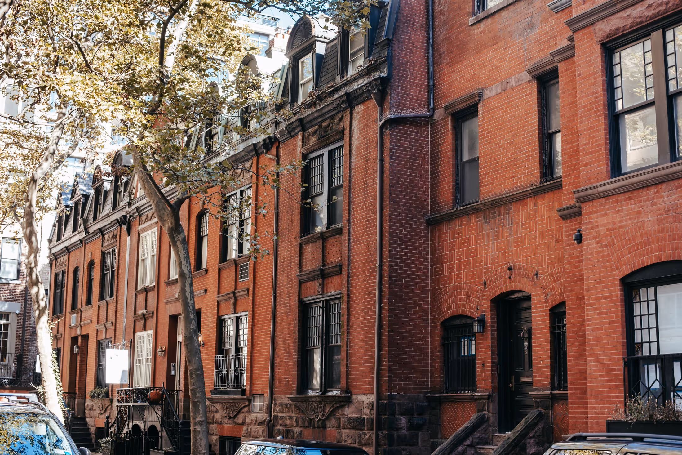 A row of brick houses on a Pittsburgh street